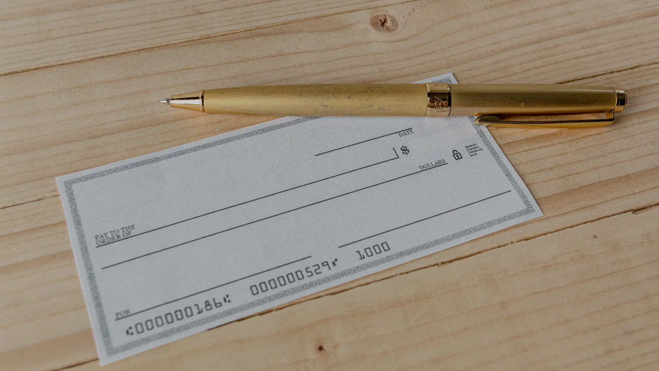 A blank check with a ballpoint pen