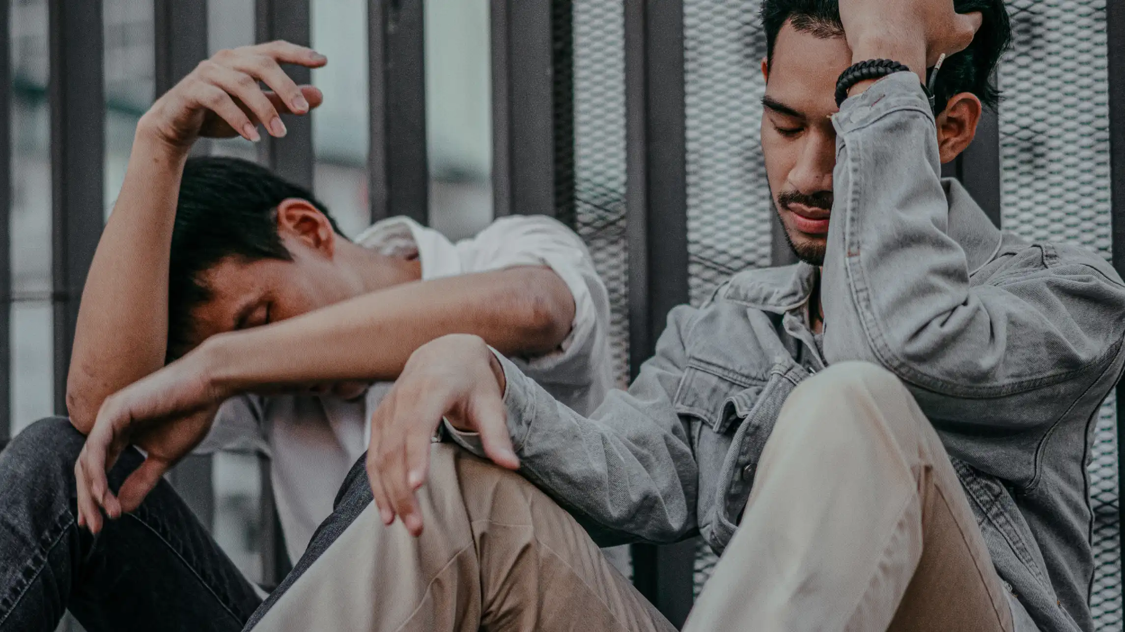 Two men passing out in the street