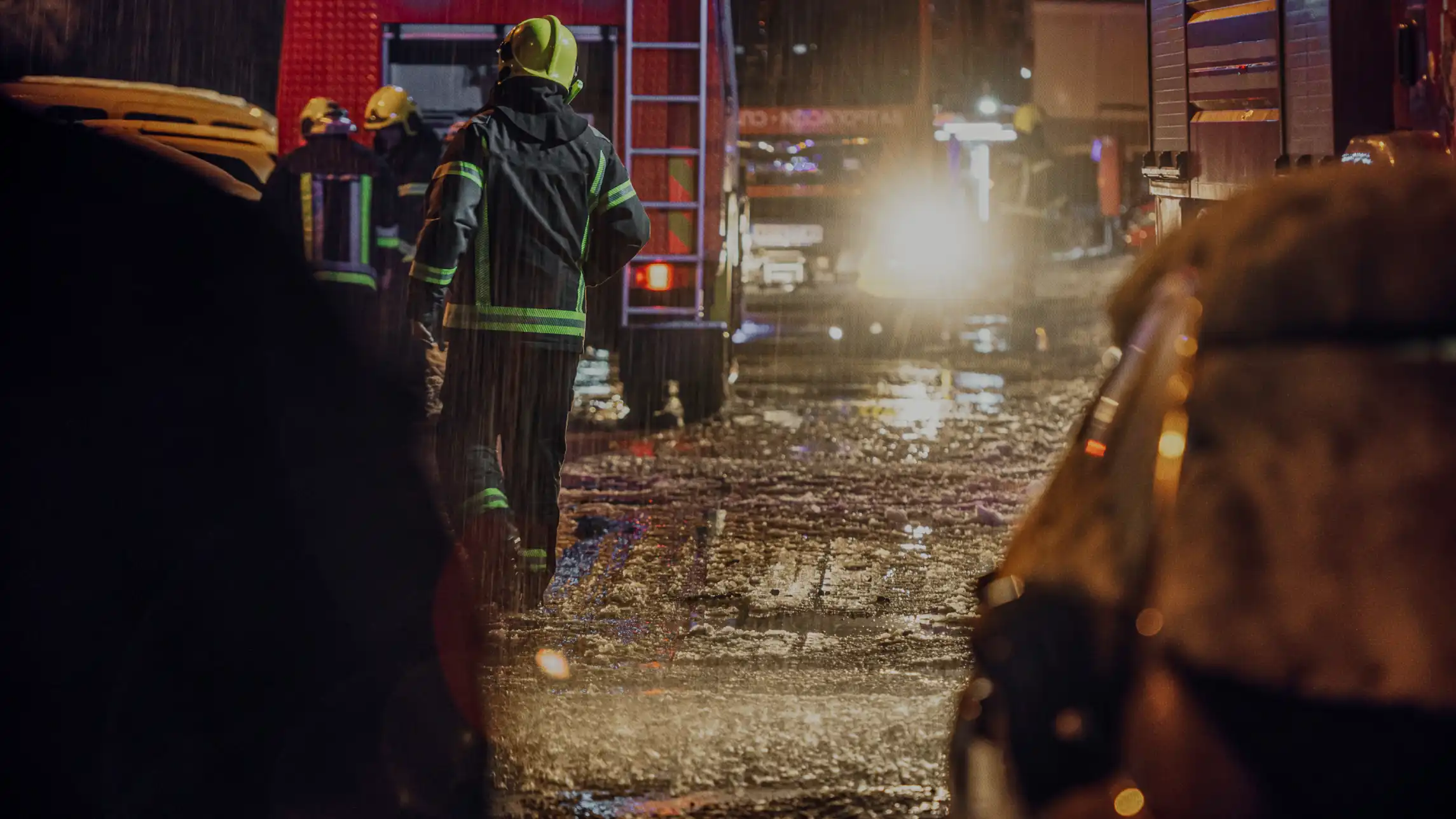 Firefighters putting out building fire in the rain