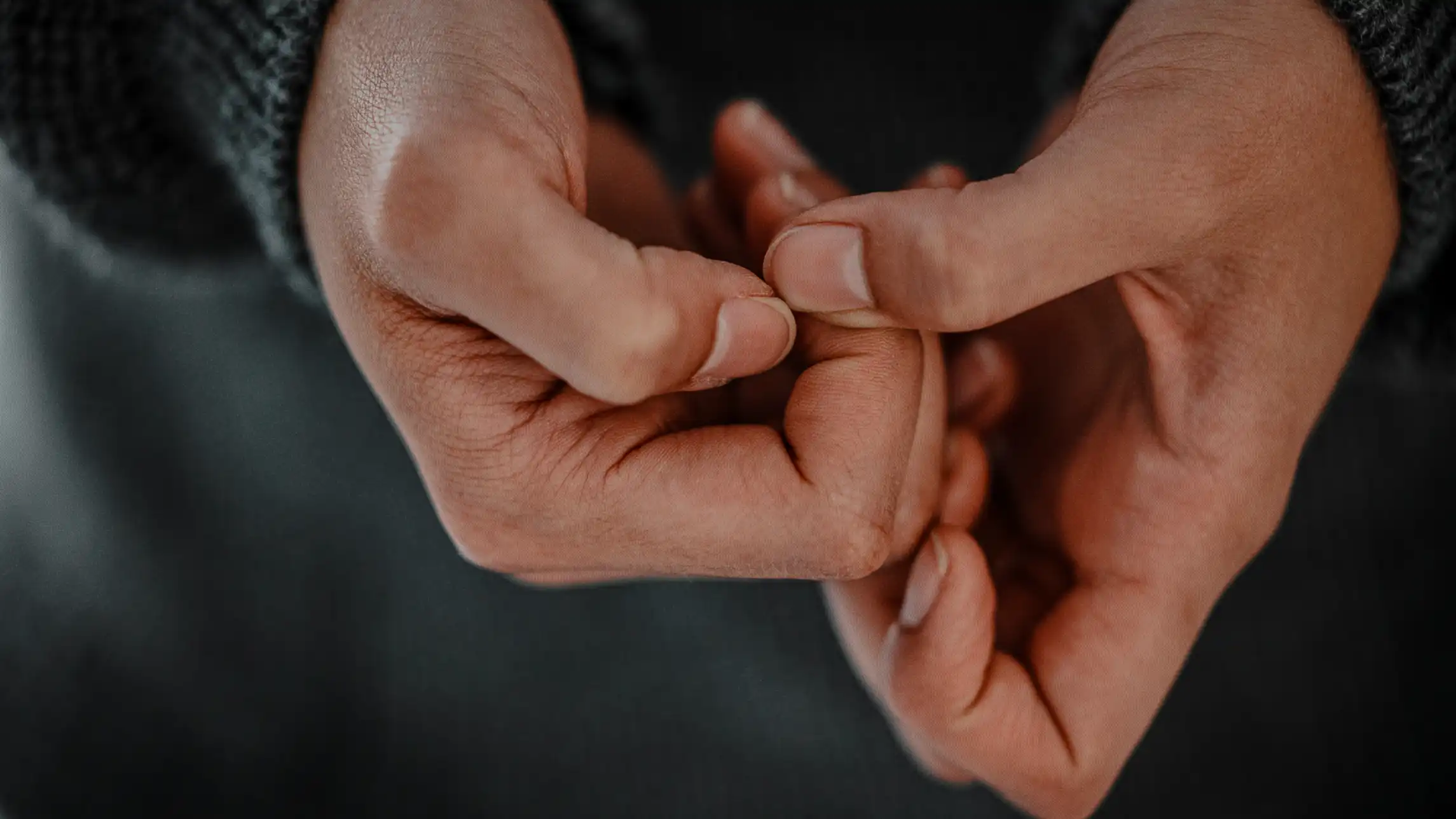 Person picking nails nervously