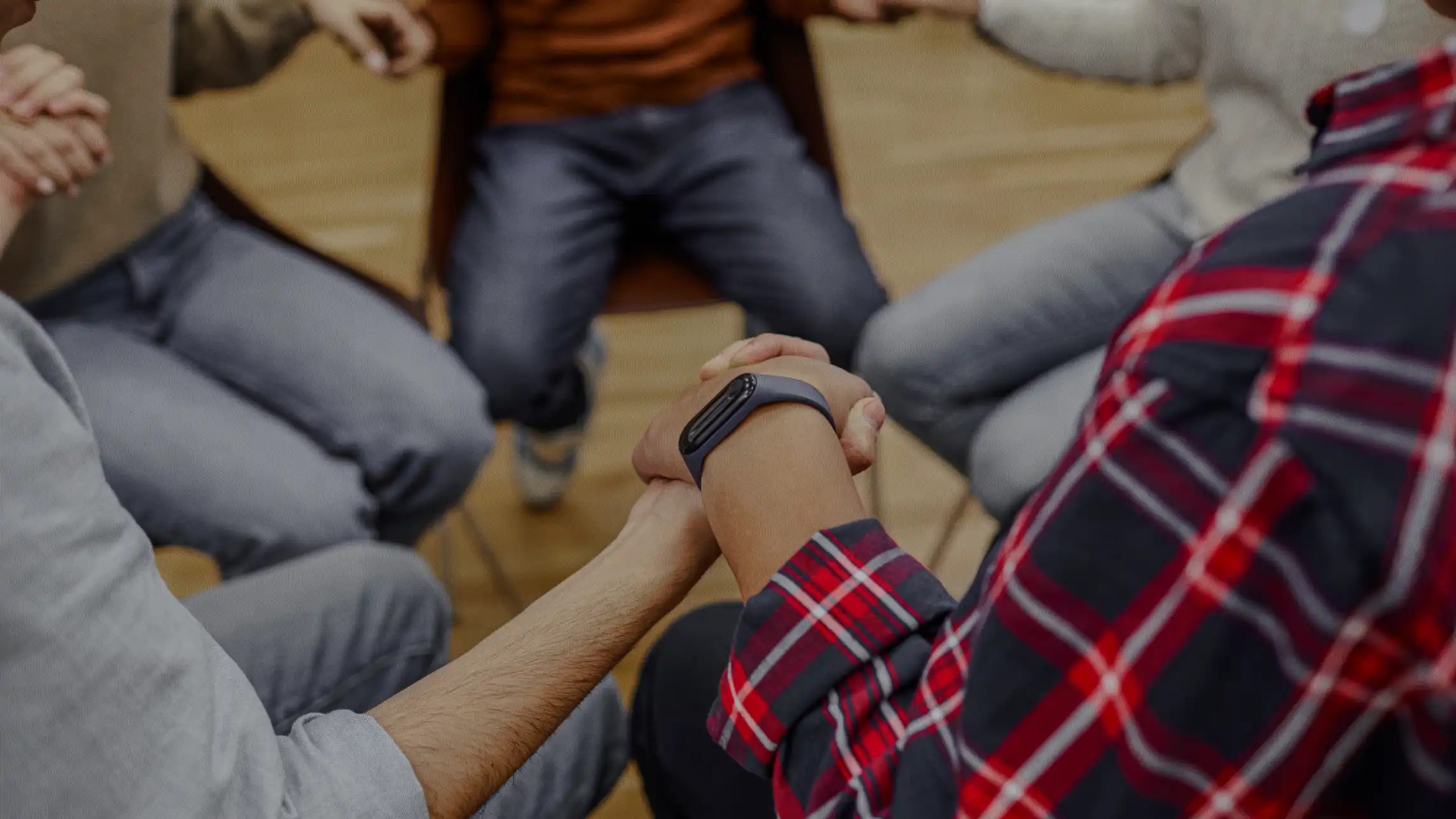 Support group holding hands in circle