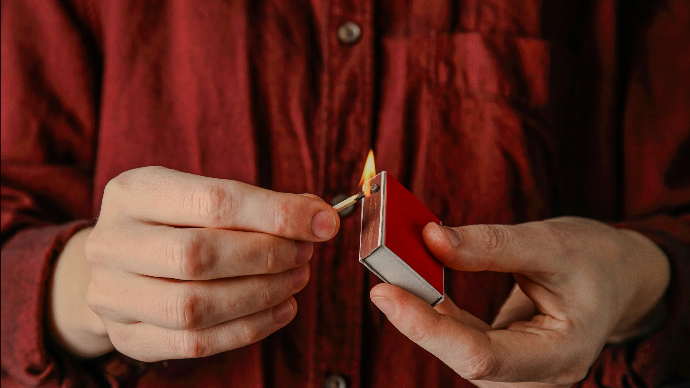 Man ignites flame on matchbox