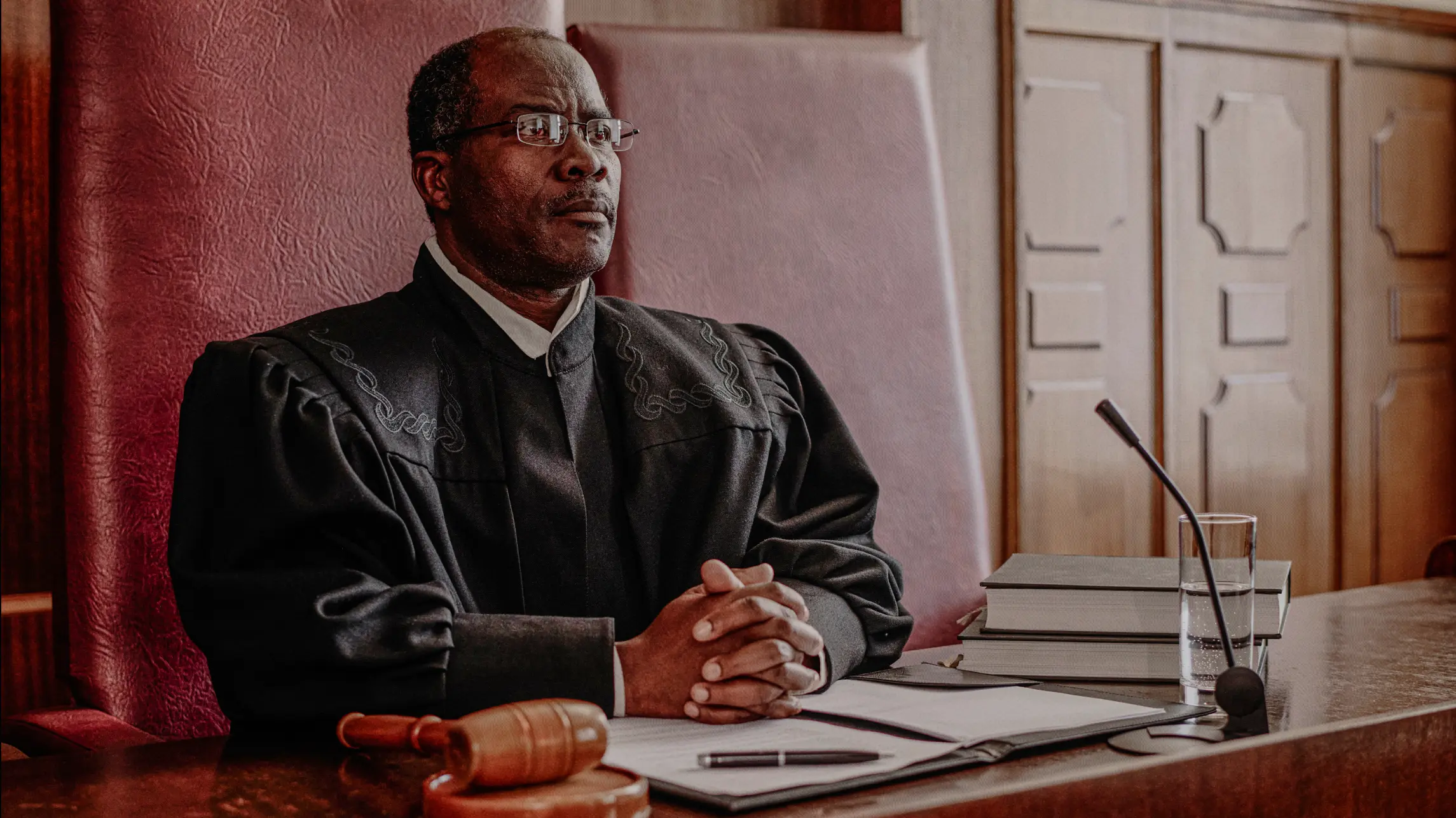Judge sits at bench in courtroom waiting to hear testimony