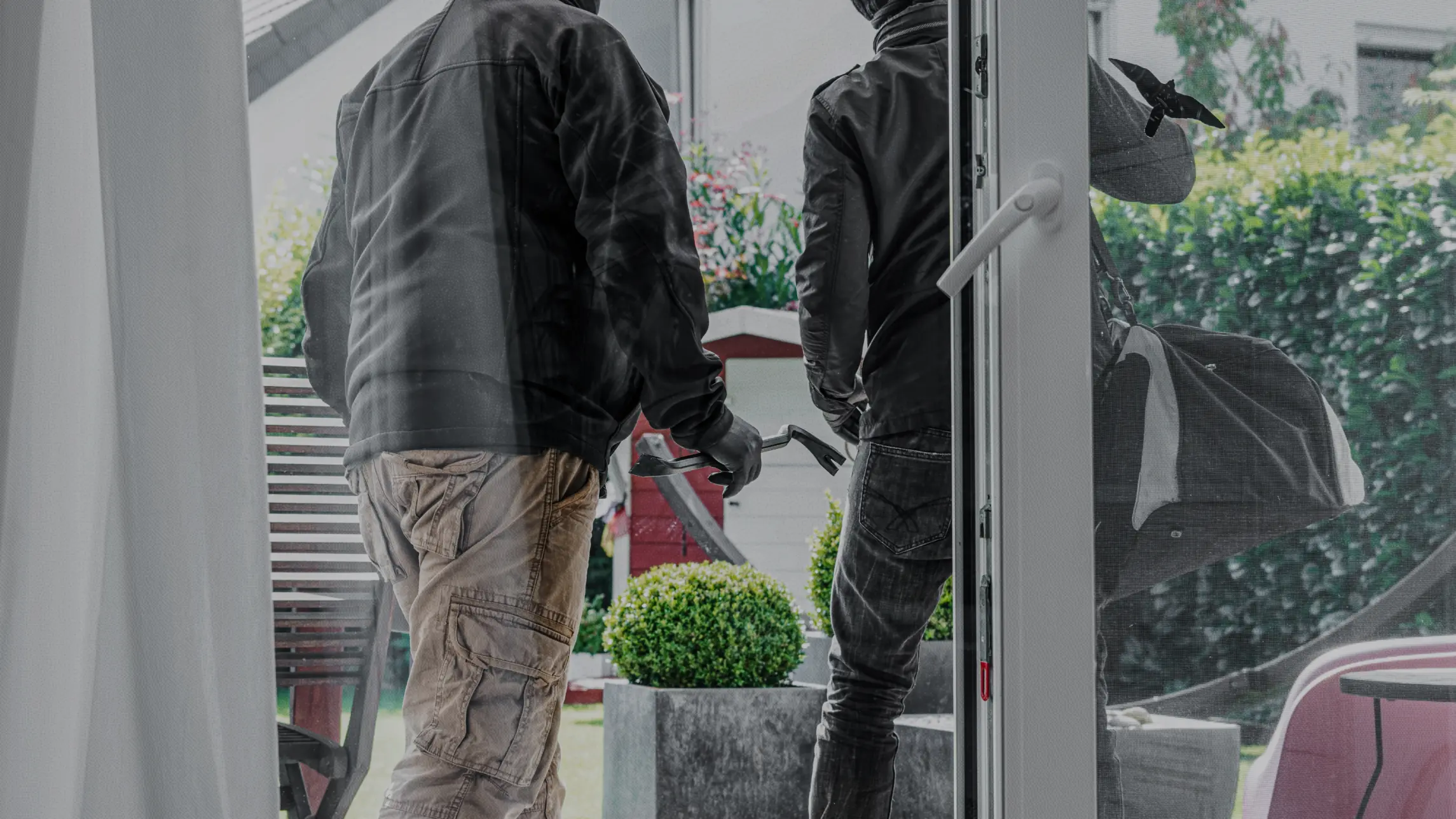 Burglars leaving home with prized possessions crowbar in hand