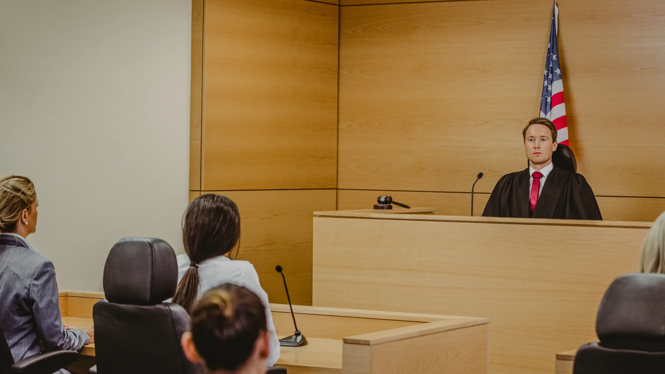 Judge presiding before courtroom with woman on trial