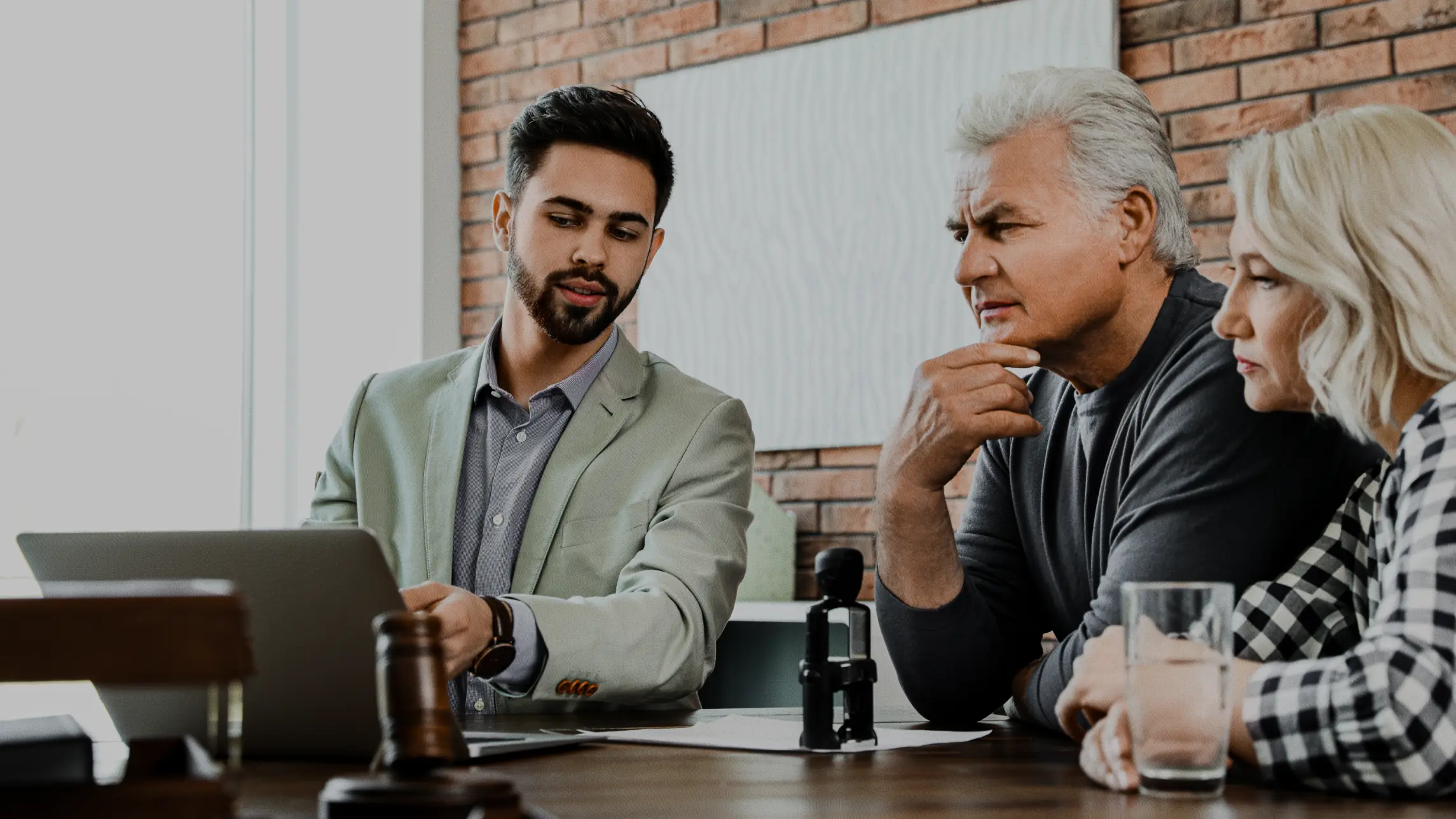 Business man explaining idea to man and woman looking in deep thought