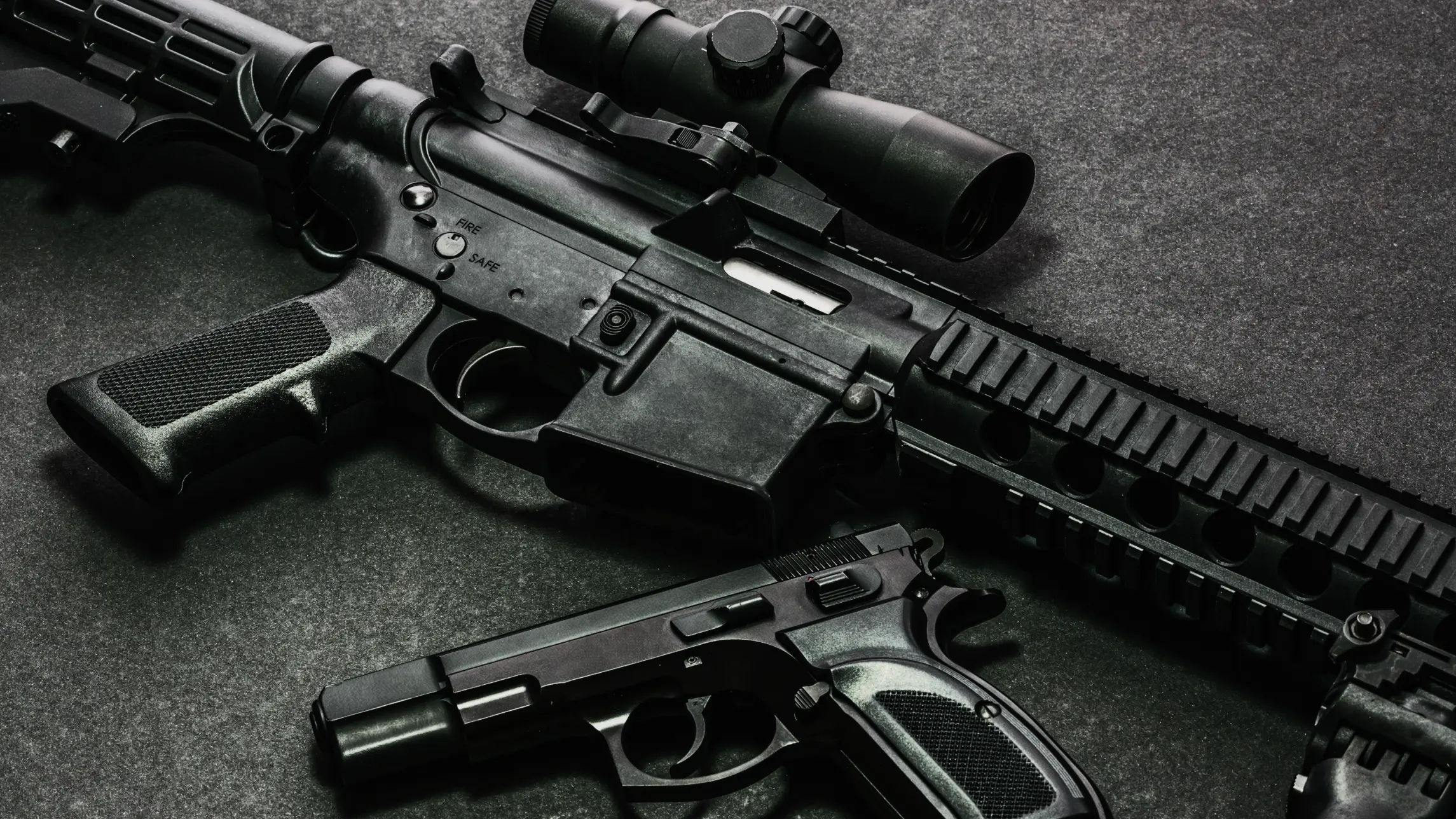 Assortment of guns laying out on a table