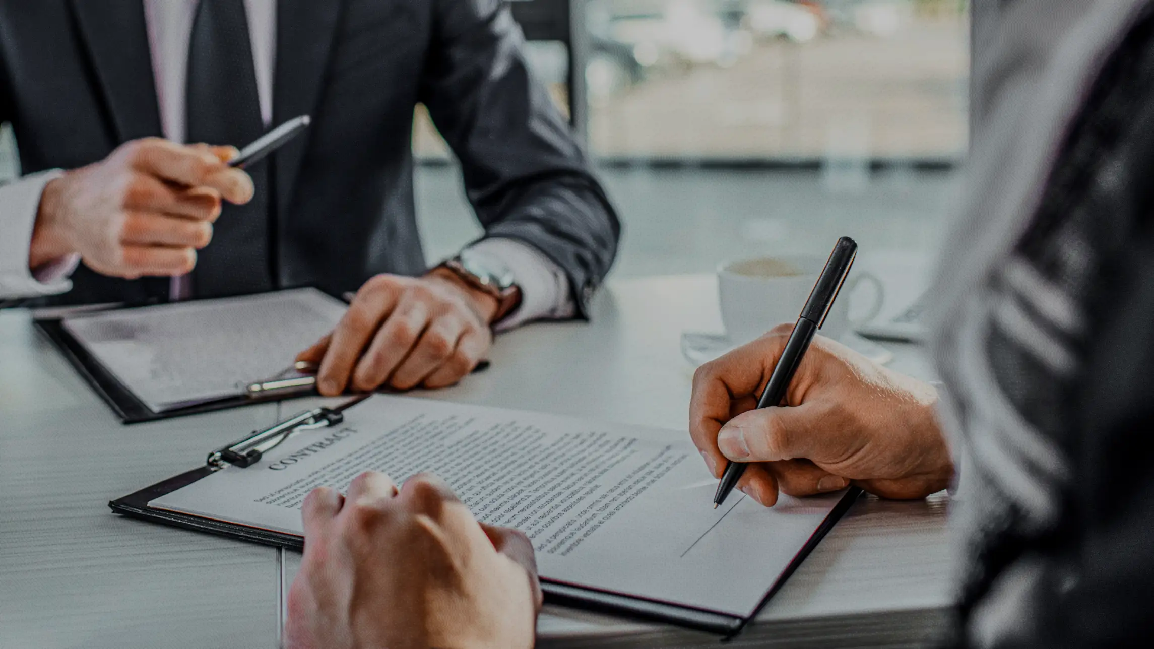 Man signing paperwork in office