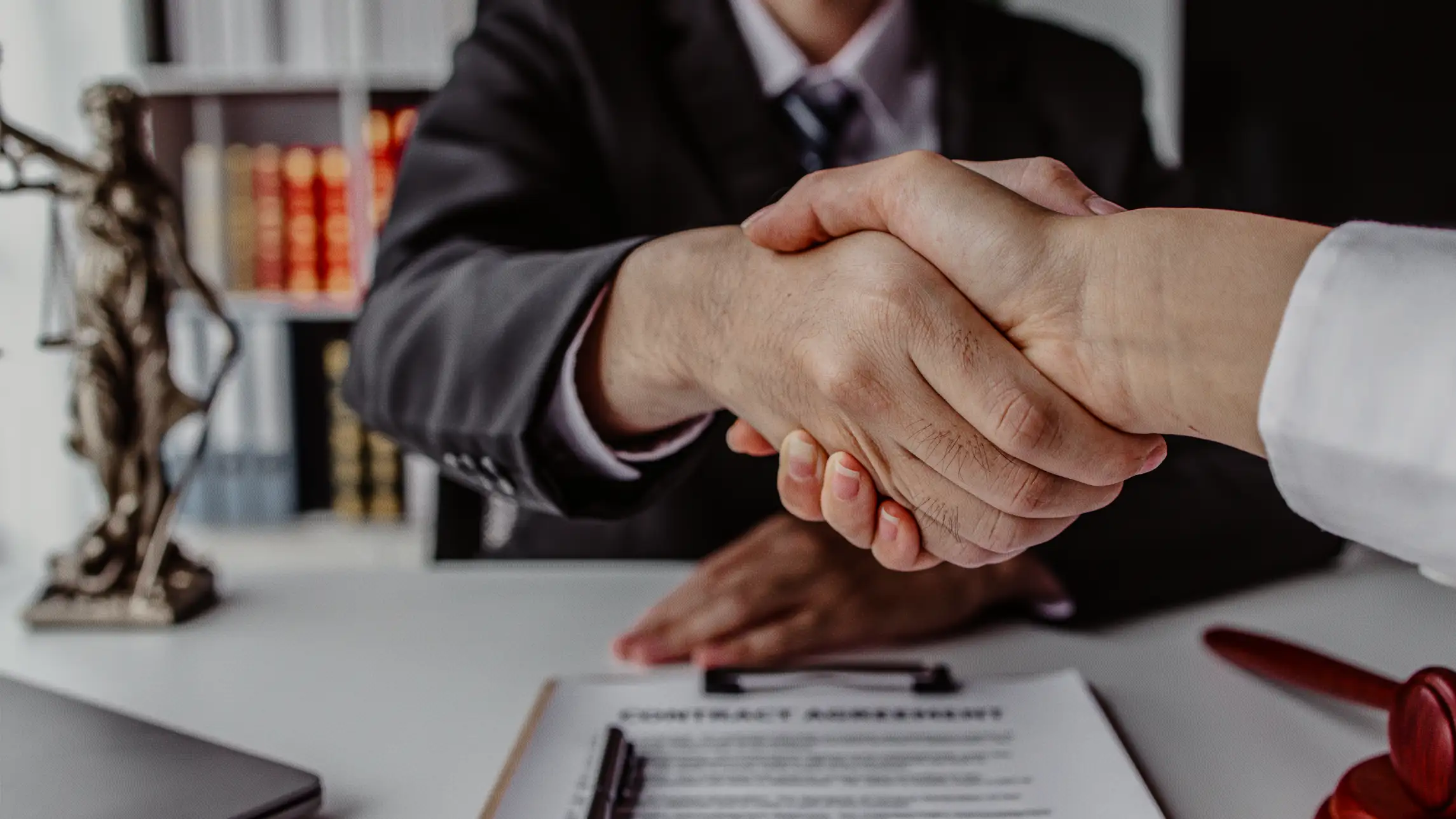 Shaking hands over paperwork
