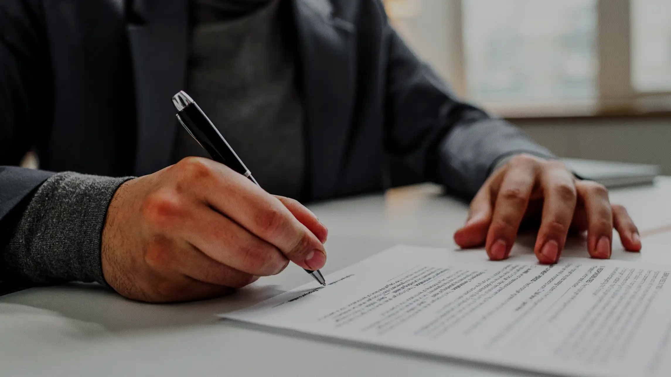 Man signing name on bail bond application