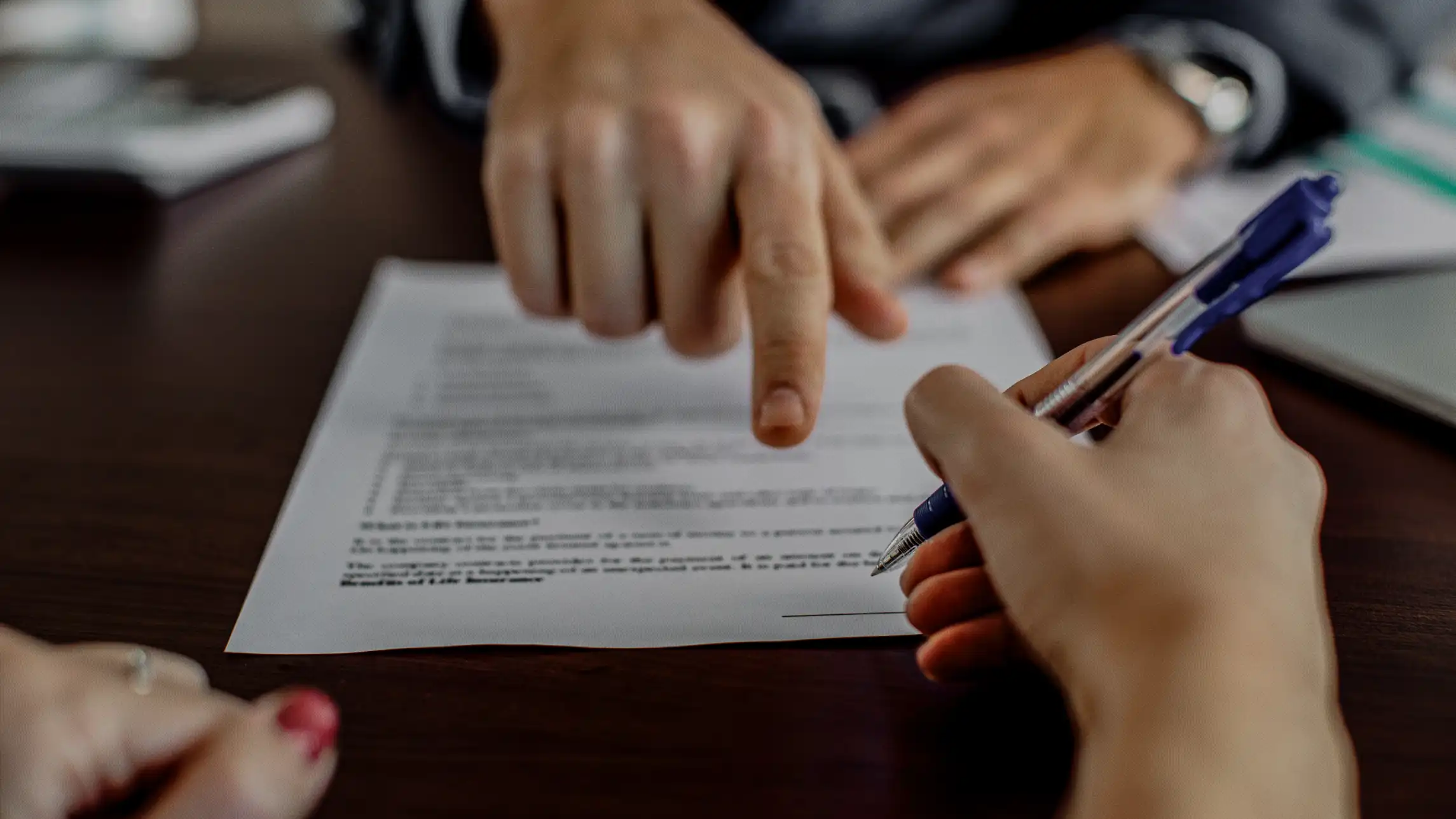 Bail agent pointing where to sign