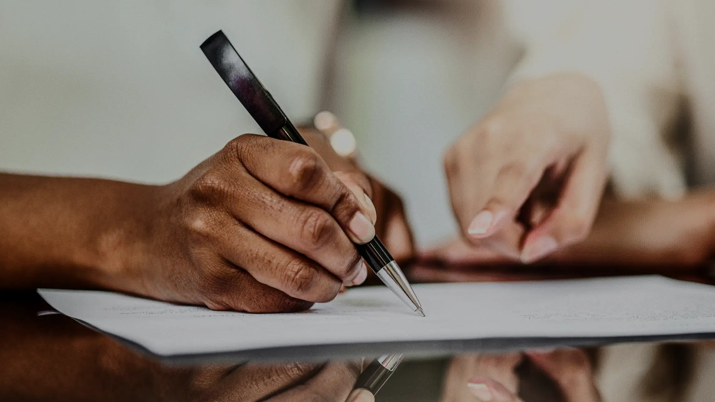 Man signing paperwork with local bail bond agent