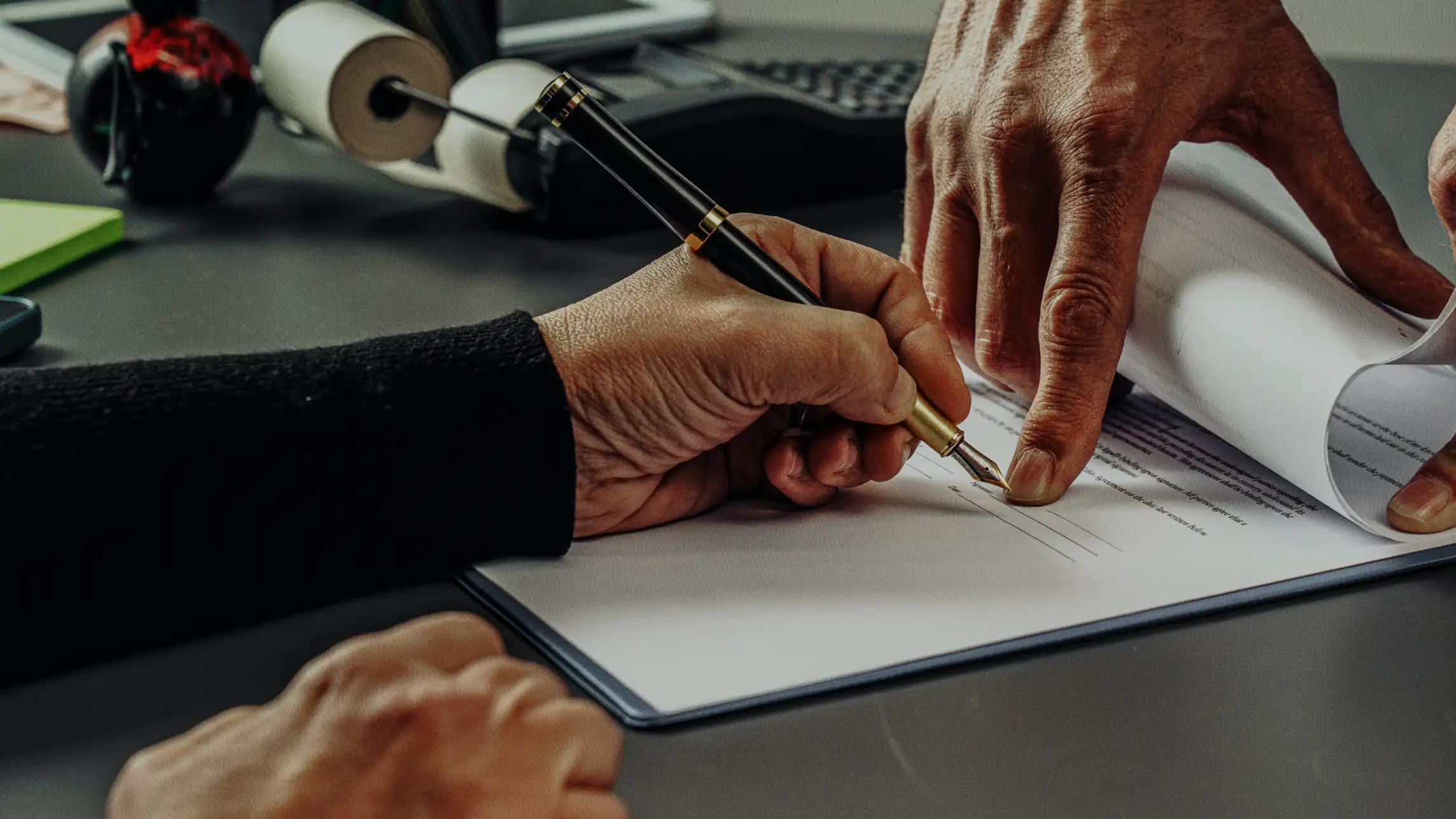 Person signing on dotted line of bail bond application