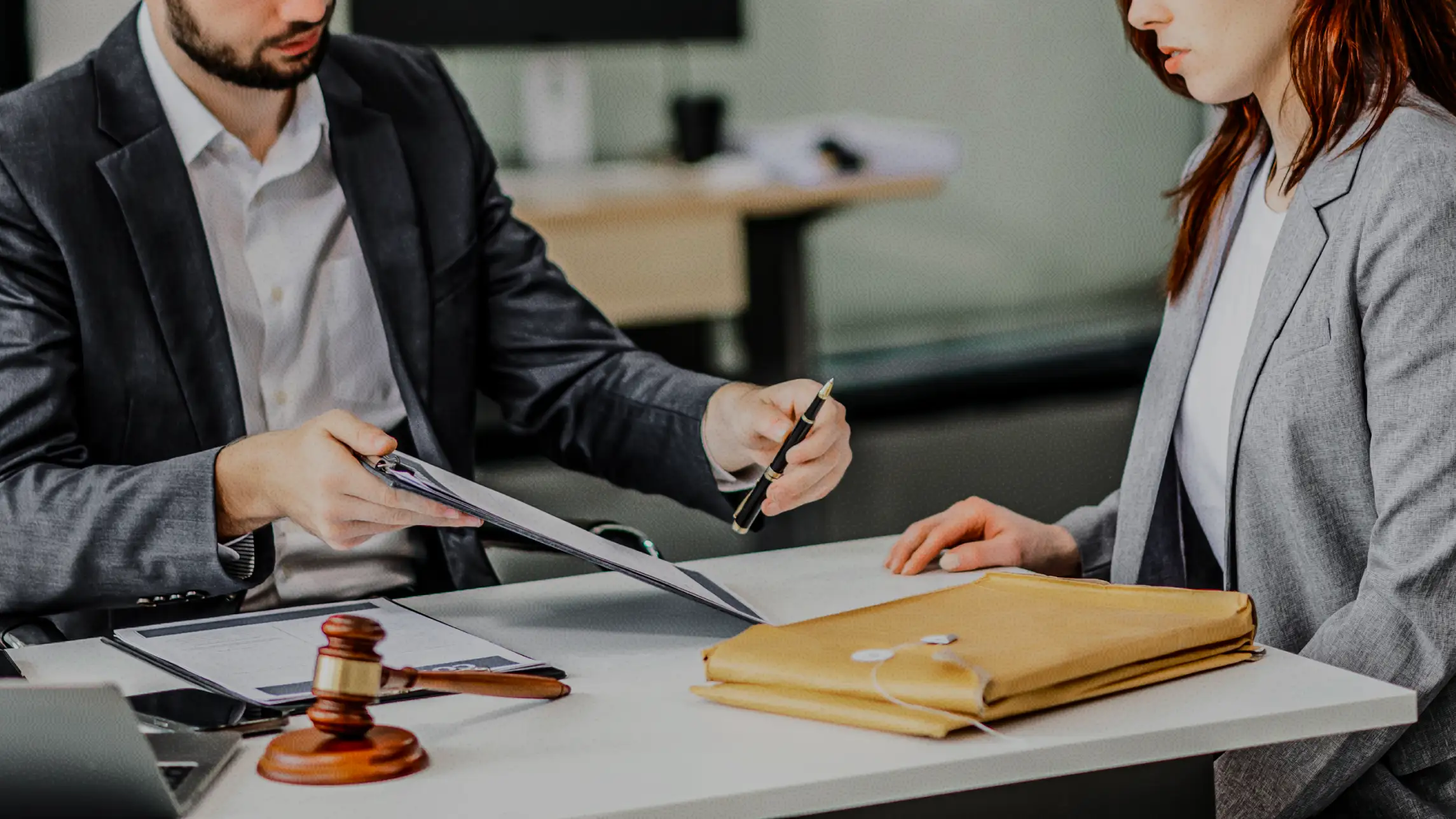 Woman signing paperwork in local bail bonds agency office